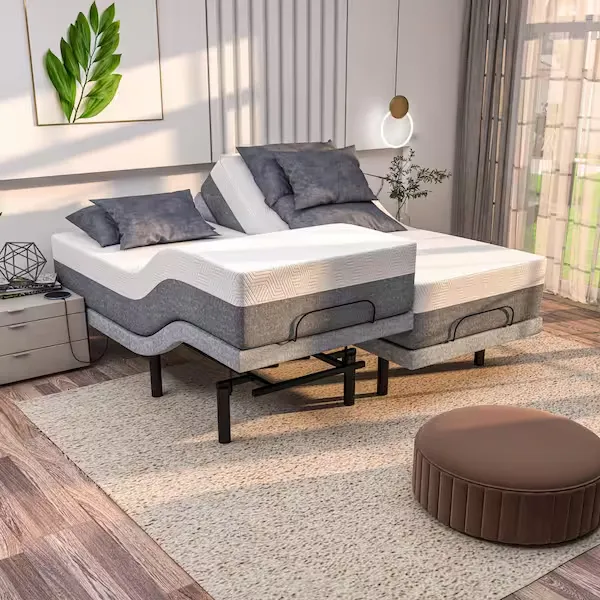 A split king adjustable FOK959S-M model bed with two separate mattresses, each in an elevated position, shown in a modern bedroom setting with grey bedding.
